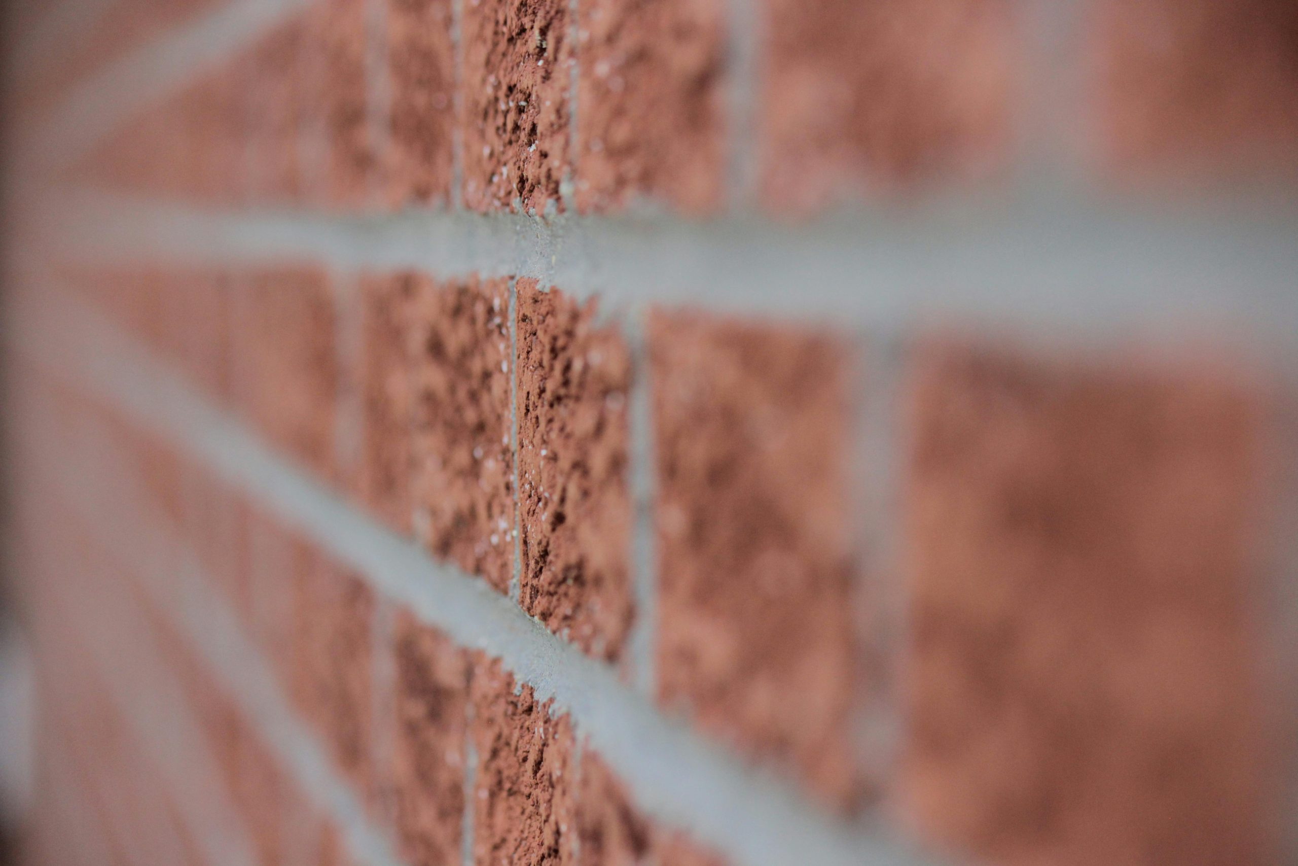 Artistic close-up of a red brick wall showcasing texture and depth of field.